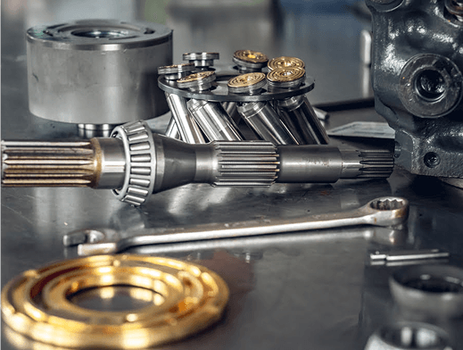 Disassembled hydraulic pump components and tools on workbench